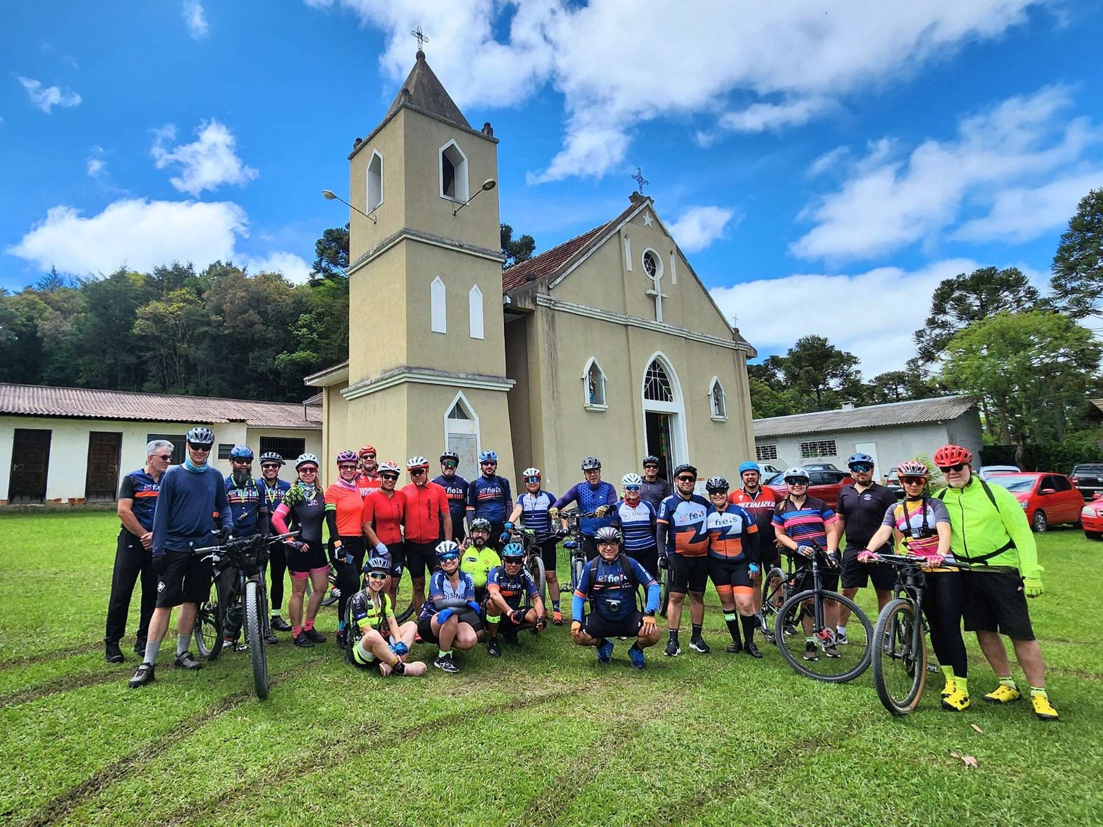 Grupo de ciclistas no Cicloturismo em Campina Grande do Sul se preparam para pedalada em frente a Igreja. 